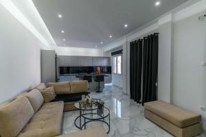 a living room with a couch and a table at Gkr Luxury Apartments Metro Petralona in Athens