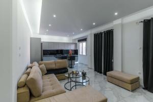 a living room with a couch and a table at Gkr Luxury Apartments Metro Petralona in Athens
