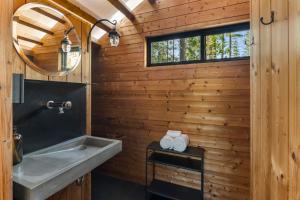 a bathroom with a sink and a mirror at Under Canvas Yosemite in Groveland