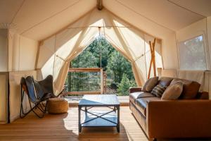 a living room with a couch and a tent at Under Canvas Yosemite in Groveland +28 photos
