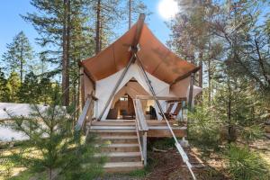 a luxury tent in the woods with a roof at Under Canvas Yosemite in Groveland