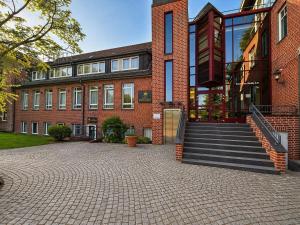 ein Backsteingebäude mit einer Treppe davor in der Unterkunft Hotel Schwarzenbek in Schwarzenbek