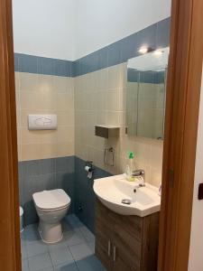 a bathroom with a toilet and a sink and a mirror at LA Tulè 2 in Popoli +29 photos