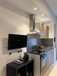 a kitchen with a sink and a stove top oven at LA Tulè 2 in Popoli