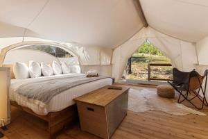 a bedroom with a bed in a tent at Under Canvas Yosemite in Groveland