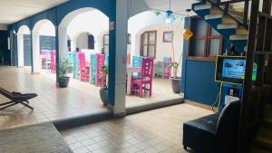 a reflection of a room with chairs and a tv at Jardines de Luz in San Cristóbal de Las Casas