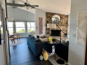 a living room with a blue couch and a fireplace at Canyon Lake House with Lake View in Canyon Lake