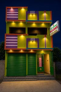 a store front with green doors and a sign on it at G3 house Pondicherry in Pondicherry