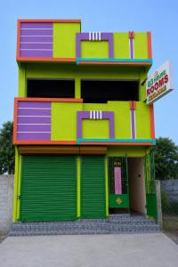 a brightly colored building with a store at G3 house Pondicherry in Pondicherry