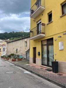 a yellow building on the side of a street at LA Tulè 2 in Popoli