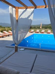 a view of a pool with a mosquito net at Narnia Cottages in Bazalet'i
