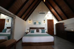 a bedroom with two beds in a room at Aalanga Escape by Lush Villa in Kanugala