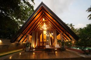 a small house with two chairs in front of it at Aalanga Escape by Lush Villa in Kanugala