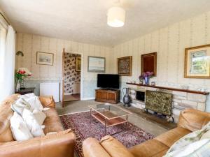 a living room with a couch and a fireplace at The Lodge in Colchester