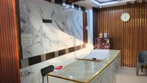 a office with a glass table with a laptop on it at HOTEL BPR Residency in Hyderabad