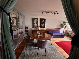 a living room with a table and chairs at Royal Apartment 02 in Schaan
