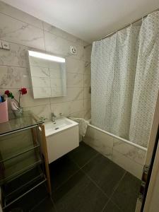 a bathroom with a tub and a sink and a shower at Royal Apartment 02 in Schaan +27 photos