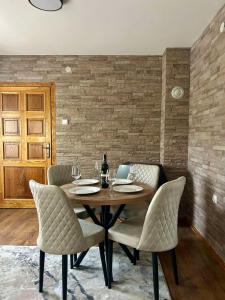a dining room with a wooden table and chairs at Mont Peak Apartment in Kolašin