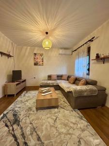a living room with a couch and a table at Mont Peak Apartment in Kolašin