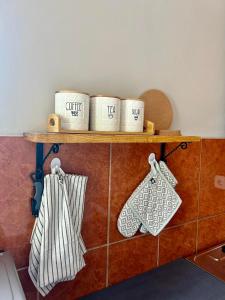 a shelf with three coffee cups on top of a wall at Mont Peak Apartment in Kolašin +6 photos