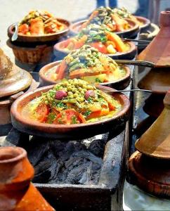 a bunch of pizzas sitting on top of a grill at Atlas Rooftop Imlil in Imlil +30 photos