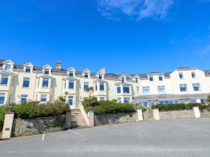 a large white building with a parking lot in front of it at Ewyn Y Don in Holyhead