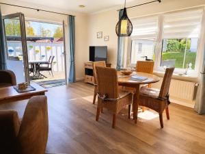 a living room with a wooden table and chairs at Ferienhaus SOL - in Staphel