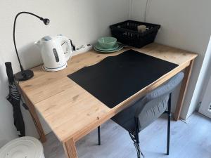 a wooden table with a toaster on top of it at De Groene Oase in Harkstede