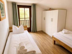 a room with two beds and a window at Horner Viehweid in Schwangau