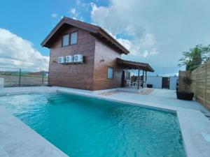 a house with a swimming pool and a building at Cabaña AlMa in Totanés