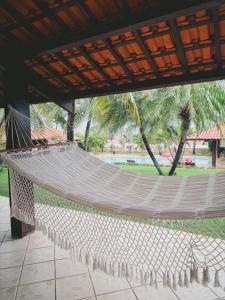 a hammock in a pavilion with a park in the background at Casa Kite Academy in Caucaia