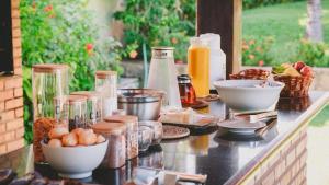 a counter topped with bowls of food and other foods at Casa Kite Academy in Caucaia