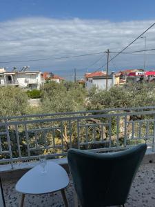 a chair and a table on a balcony at Metani Residence in Skala Sotiros +4 photos