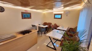 a restaurant with two tables and chairs in a room at LVMR DORMS MOHAL Bhuntar in Shamshi