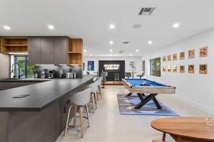 a kitchen with a pool table in the middle at Platinum Villa w Karaoke, Pickleball, BKB & Soccer in Davie