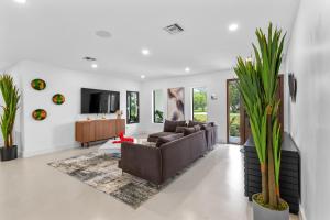 a living room with a couch and a table at Platinum Villa w Karaoke, Pickleball, BKB & Soccer in Davie