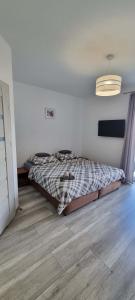 a bedroom with a bed and a ceiling at Willa North Star in Władysławowo