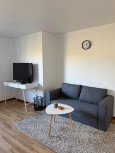 a living room with a blue couch and a table at M & M home in Karlshamn