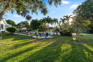 a park with benches and trees and the sun at Platinum Villa w Karaoke, Pickleball, BKB & Soccer in Davie
