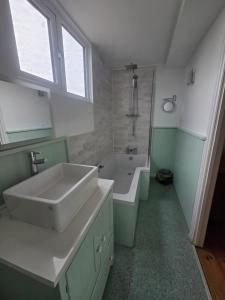 a bathroom with a sink and a bath tub at The Old Milking Parlour at Knapp Farm in Dorchester