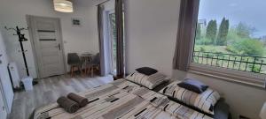 a bedroom with a bed and a large window at Willa North Star in Władysławowo