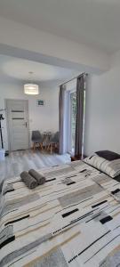 a large bed in a white room with a large bed sidx sidx at Willa North Star in Władysławowo