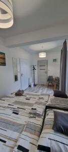 a living room with a large bed in a room at Willa North Star in Władysławowo