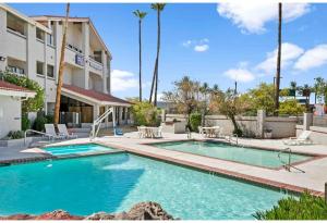 a swimming pool in front of a building at Studio 6 Tempe, AZ Elliot Road in Tempe +17 photos
