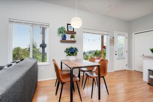 a living room with a dining room table and chairs at Ravenwood Stay With Ocean View in Victoria +21 photos