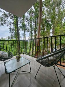 a porch with a hammock and a table and chairs at Sun Estate Ureki in Ureki