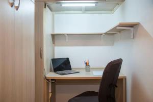 an office with a desk with a laptop and a chair at Milan Top-Floor Flat City View 2 Balconies Workspace M5 in Milan