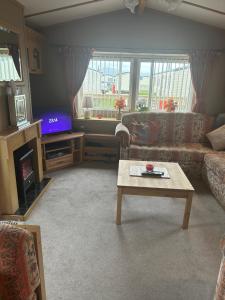 a living room with a couch and a coffee table at Nickys happy place in Greencastle