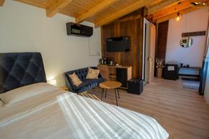 a bedroom with a bed and a living room at Casa Kaf in Sebeşel