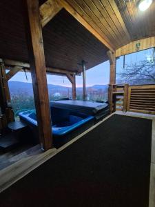 a large blue tub in a room with a view at Vatra Strabunilor in Moigrad